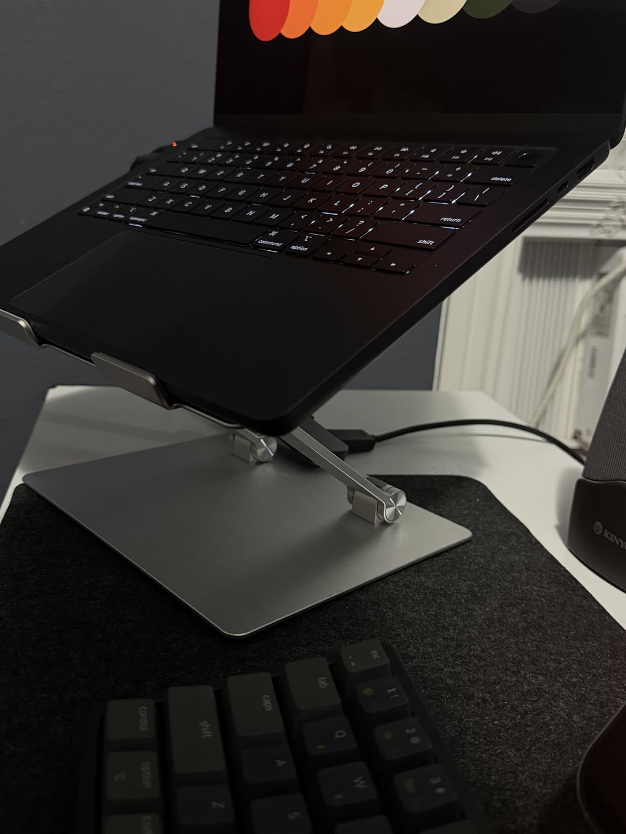 Amazon Basics Sturdy and Portable Ergonomic Laptop Stand for Desk, Height Adjustable Riser with Ventilated Cooling, Foldable, Fits all Laptops up to 15.6 Inch, Silver customer photo 1